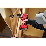  Worker using the Compact Brushless 1/2" Drill/Driver to screw in a cabinet handle