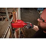 Image of the Milwaukee M12 Brushless 1-1/4" - 2" Copper Tubing Cutter being used by a worker on a jobsite to cut copper pipe