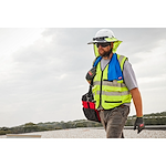 Image of a worker using the Milwaukee Cooling Towel around their neck on a jobsite