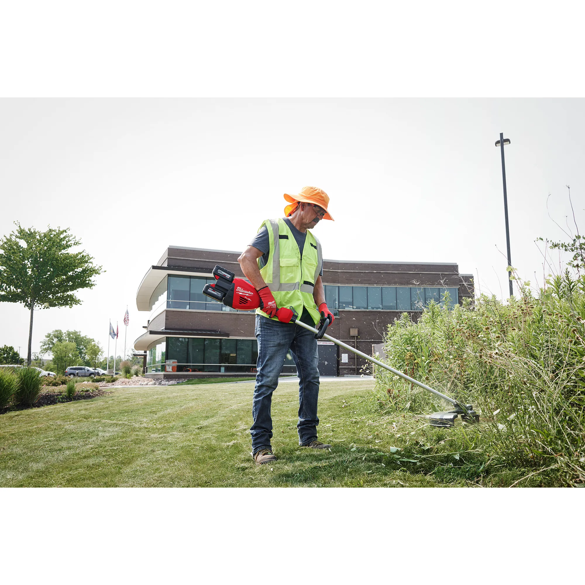 Image of a worker using the Milwaukee M18 FUEL 17” Dual Battery String Trimmer