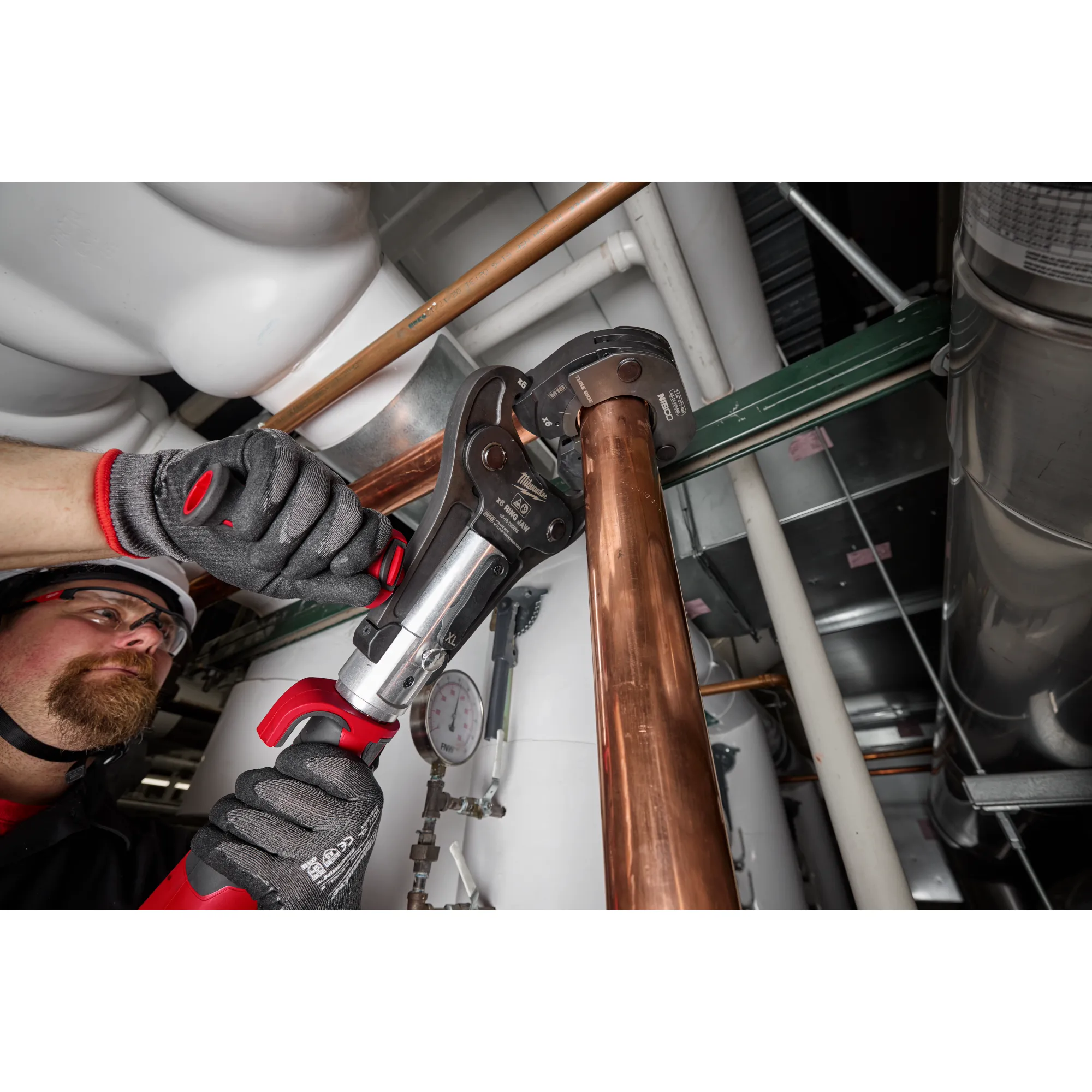 Image of a worker using the Milwaukee 2-1/2" NIBCO Press Ring with the M18 FORCE LOGIC Long Throw Press Tool