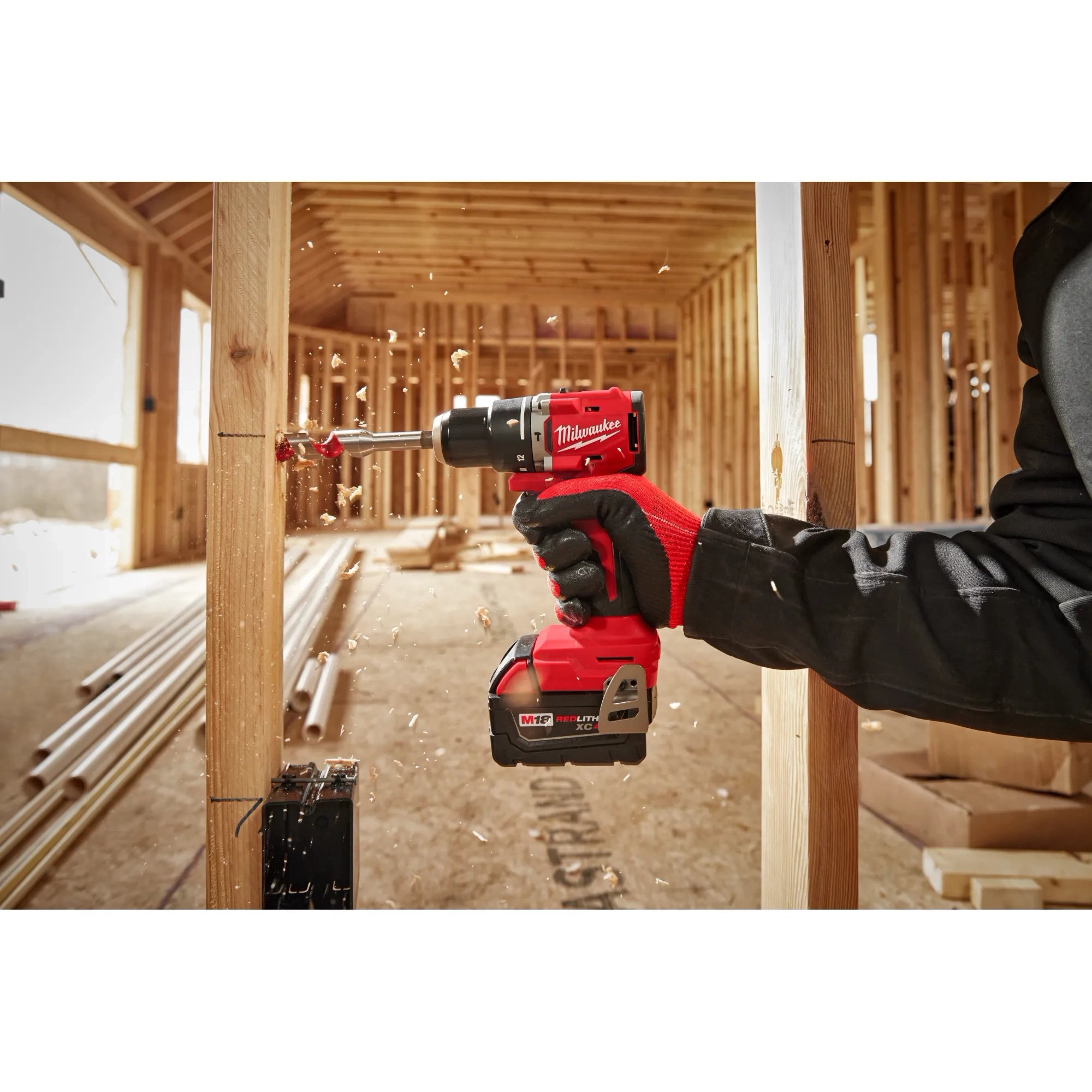 Worker using the Compact Brushless Hammer Drill/Driver to drill out a hole in wood