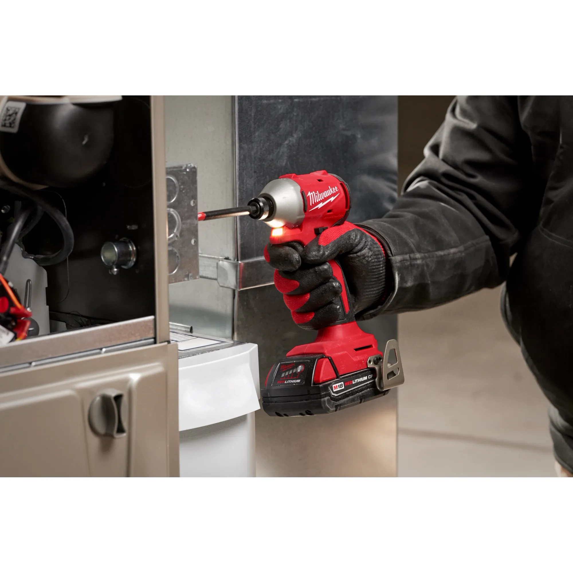 Worker using the Compact Brushless 1/4" Hex Impact Driver and LED light feature