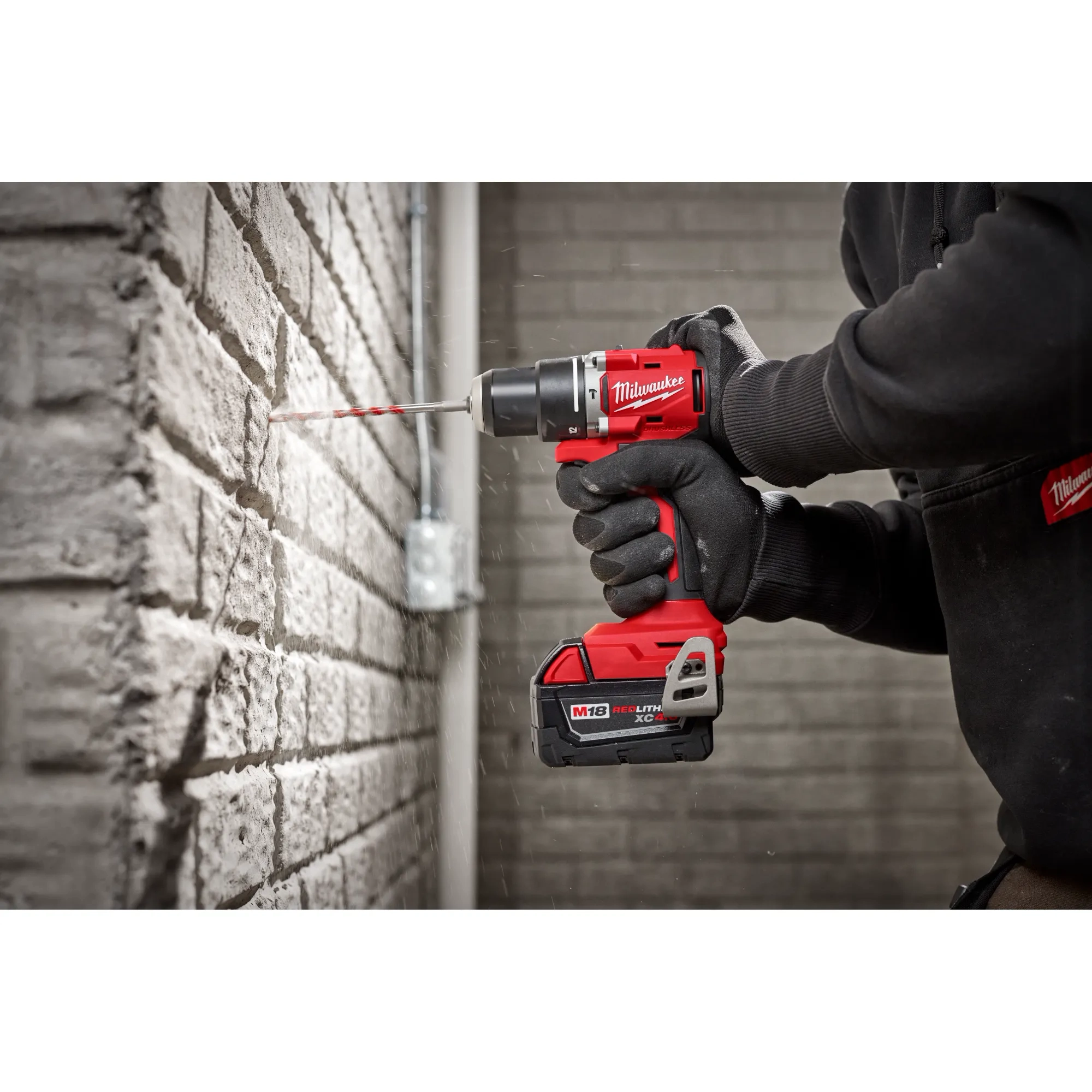 Worker using the Compact Brushless Hammer Drill/Driver to drill out a hole in concrete