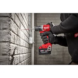 Worker using the Compact Brushless Hammer Drill/Driver to drill out a hole in concrete