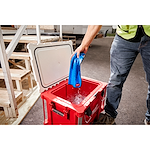 Image of a worker removing the Milwaukee Cooling Towel from a tub of water