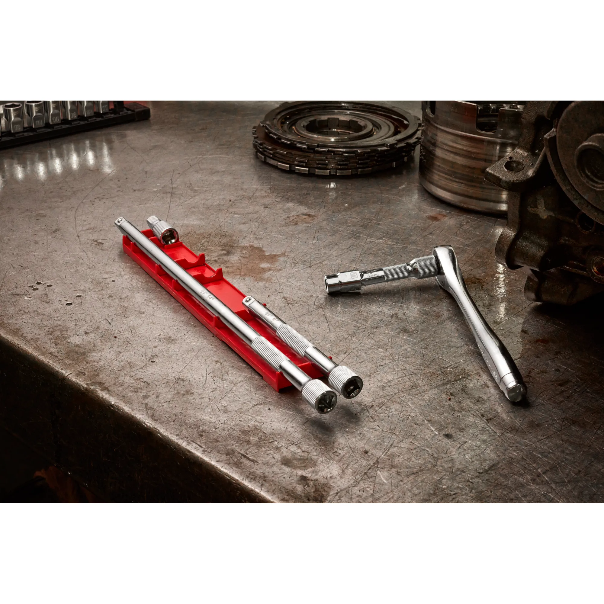 Image of the Milwaukee 4pc 3/8” Drive Extension Set on an autoshop table