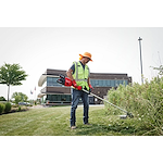 Image of a worker using the Milwaukee M18 FUEL 17” Dual Battery String Trimmer