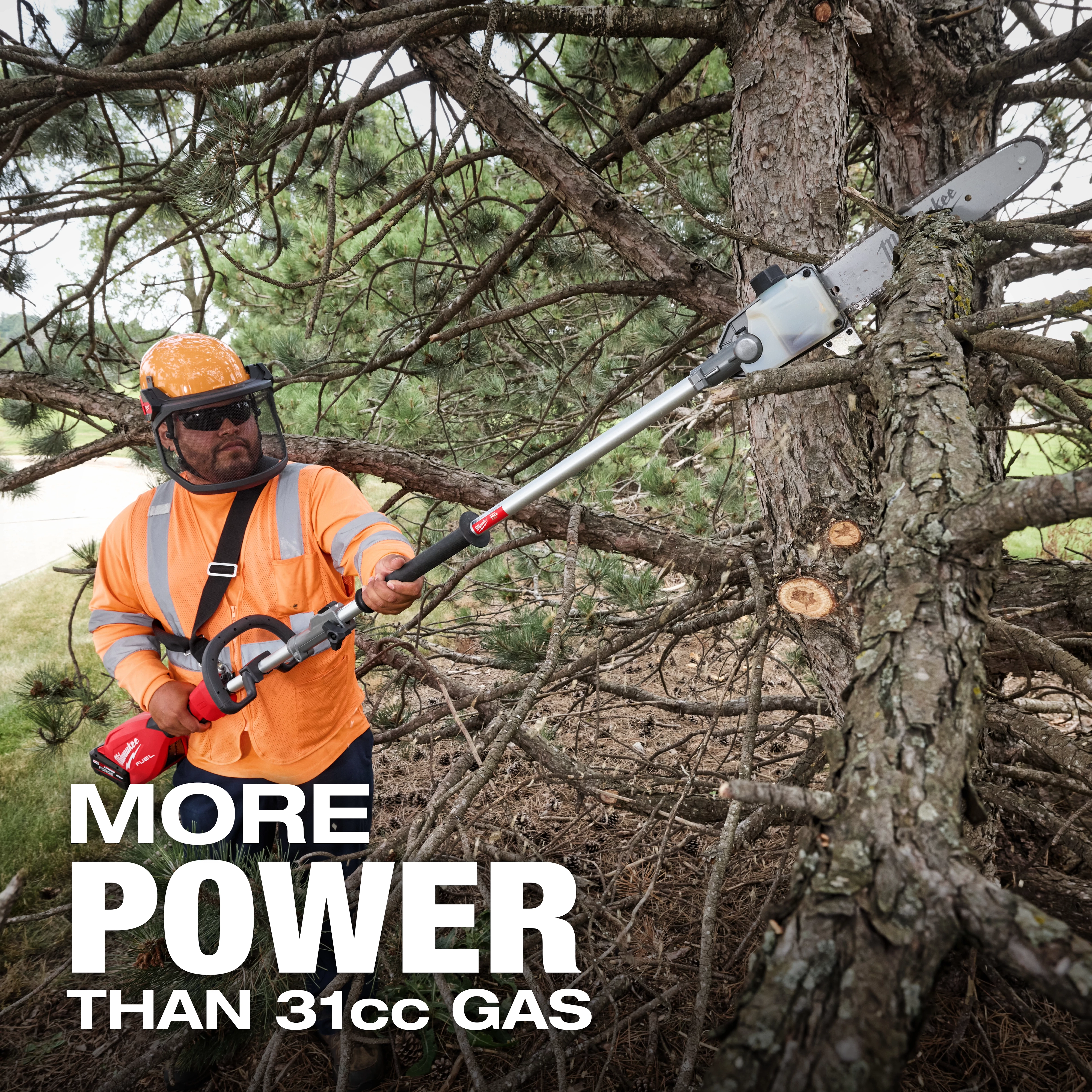 A person operates an M18 FUEL™ Pole Saw w/ QUIK-LOK™ Kit to trim a tree branch. The text on the image reads "MORE POWER THAN 31cc GAS." The person wears an orange high-visibility jacket and safety helmet, holding the pole saw in a forested area.