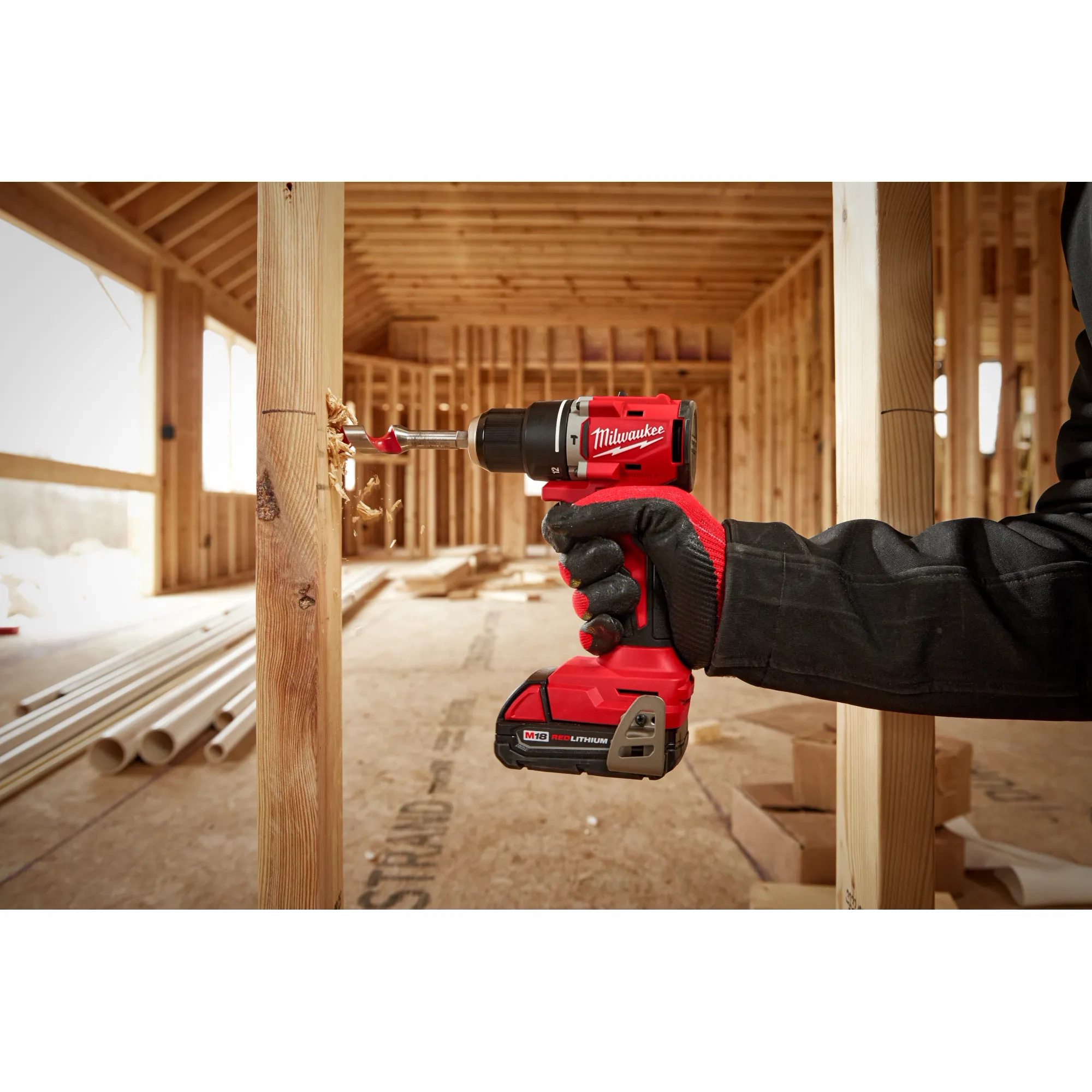 Worker using the Compact Brushless Hammer Drill/Driver to drill out a hole in wood