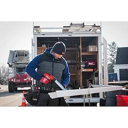 Image of a man on a jobsite wearing the Milwaukee Rib-Knit Cuffed Beanie in black