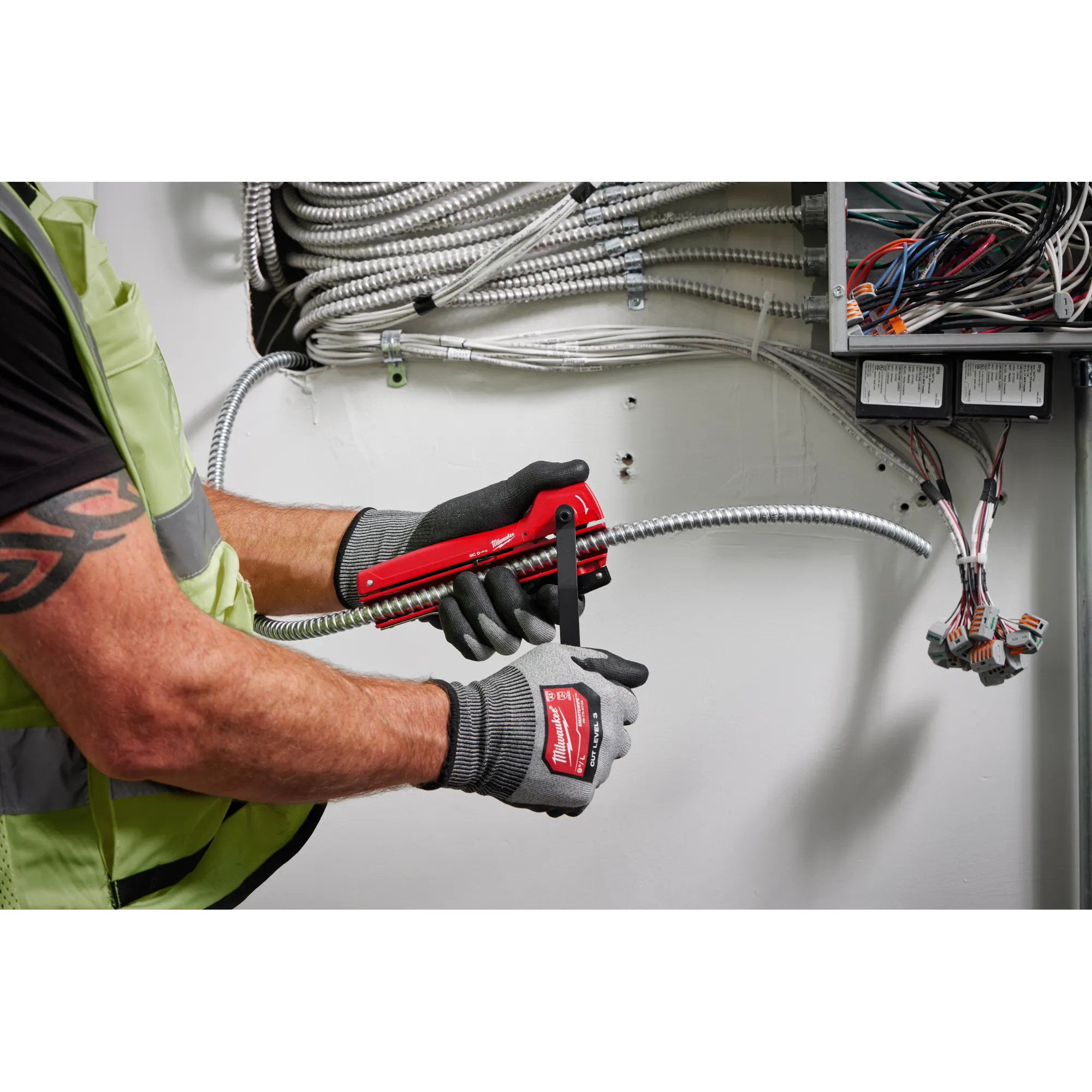 Image of a worker using the Milwaukee Armored Cable Cutter on wiring