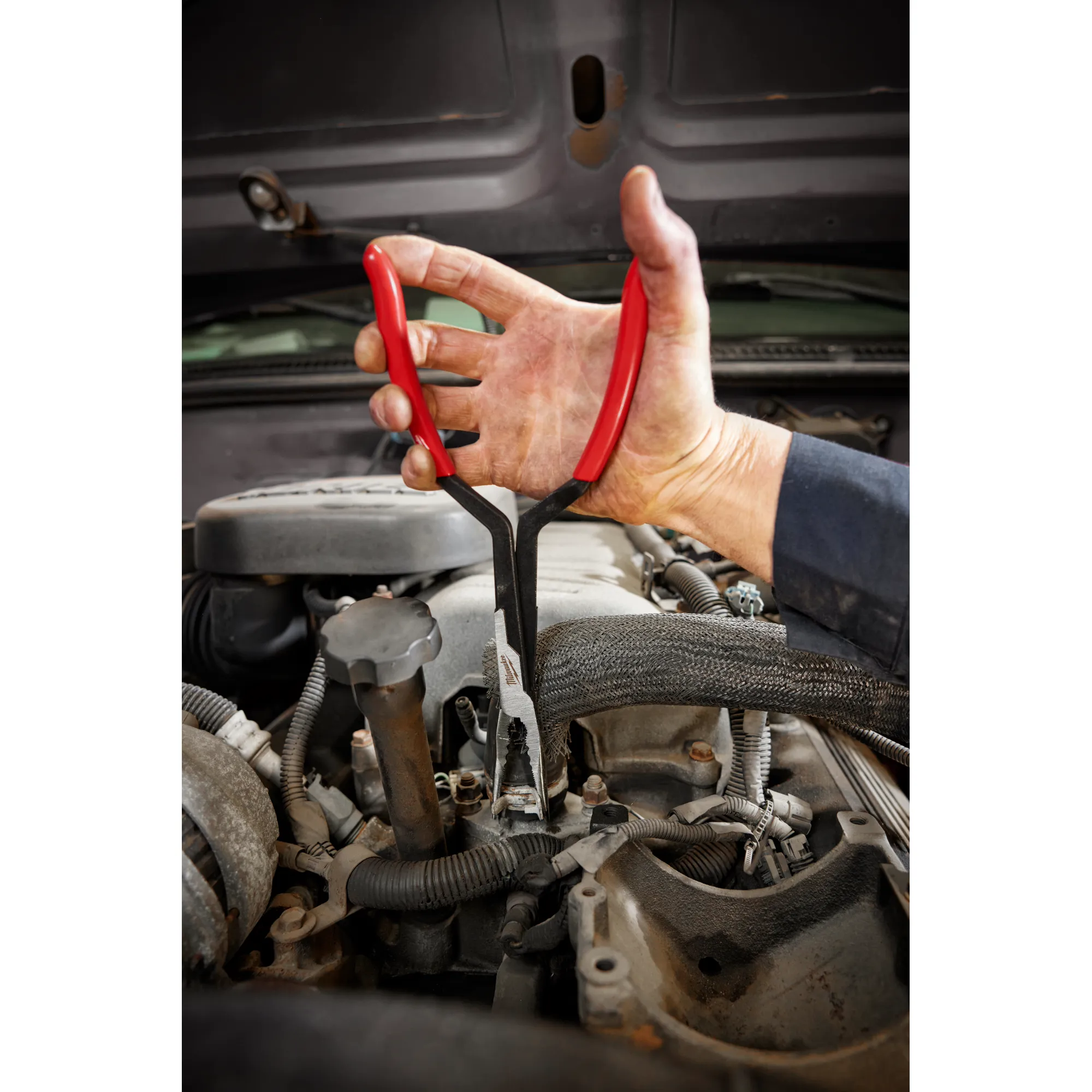 Worker using the 13" long reach pliers